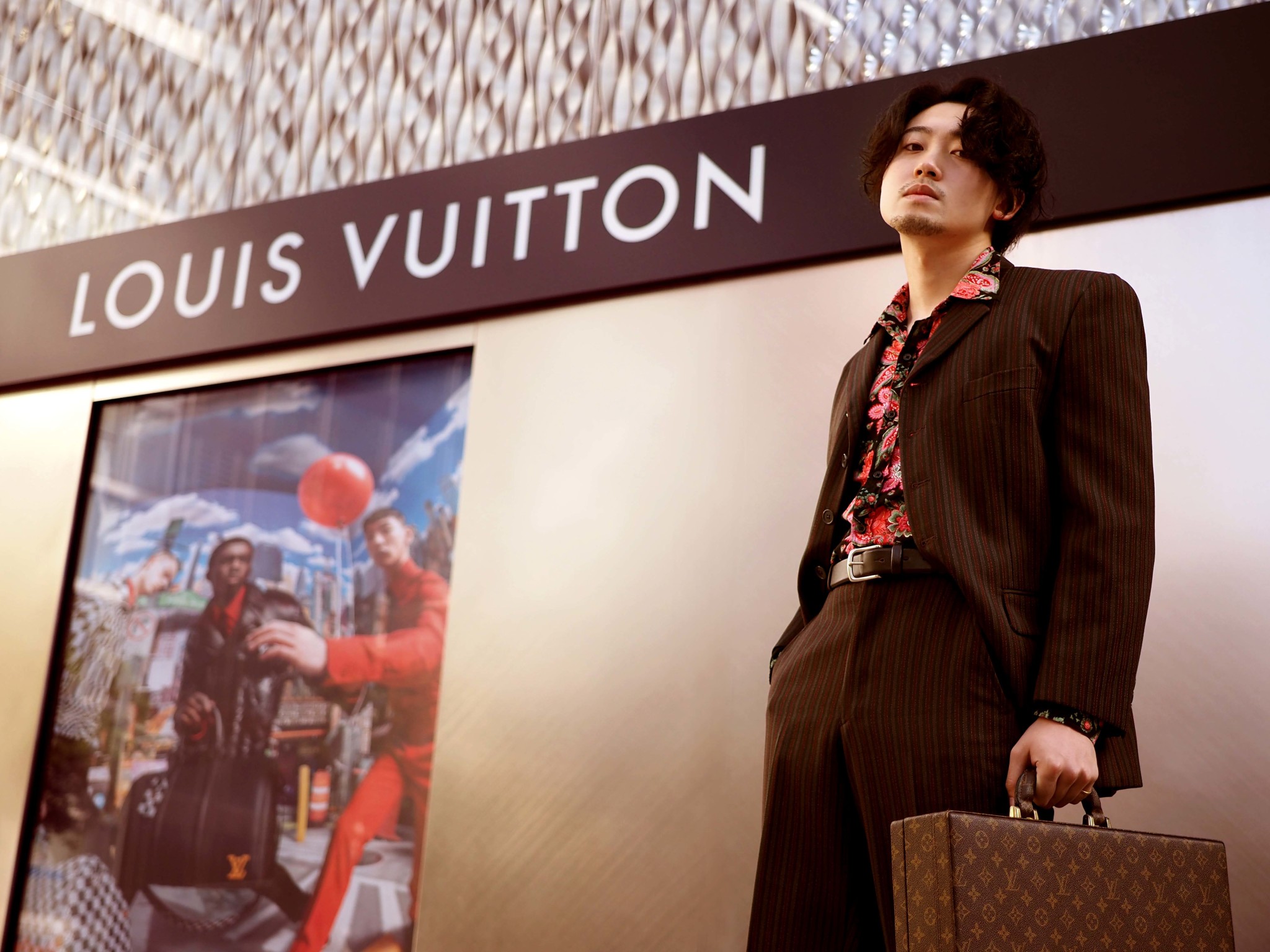 A-model-poses-at-a-Louis-Vuitton-storefront-in-Nagoya.jpg